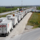 Trucks wait in a long queue to cross into US at the Nuevo Laredo bridge.